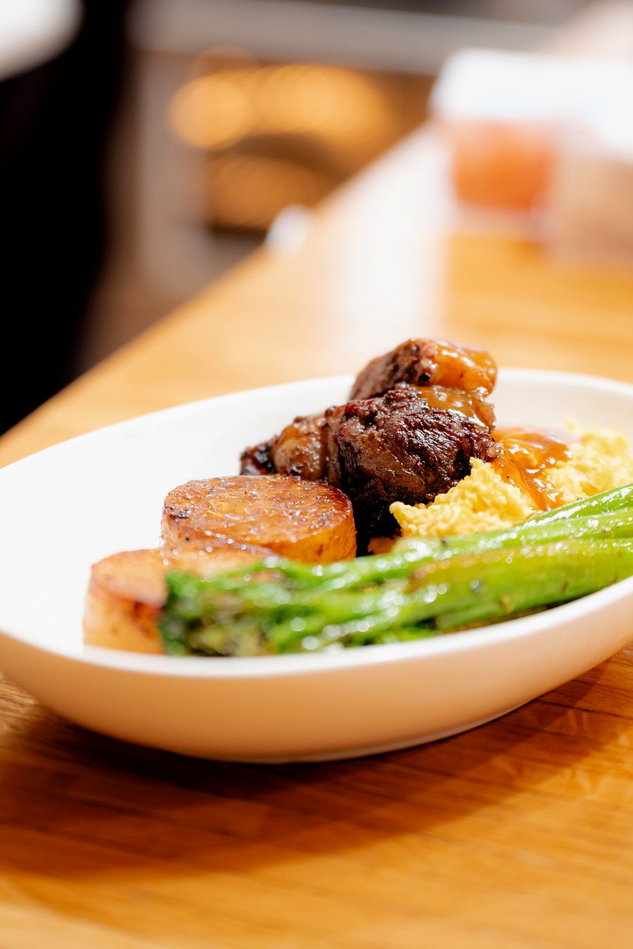 Plated steak with potato, asparagus and rice