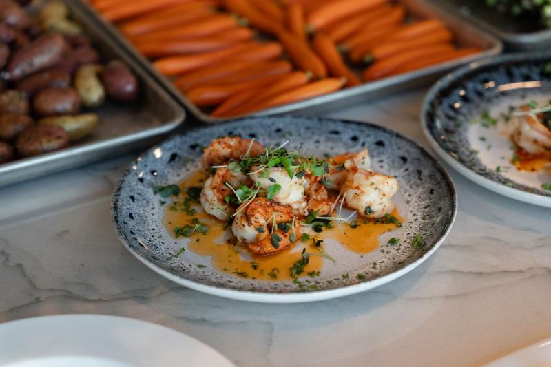 Seared shrimp plated with sauce